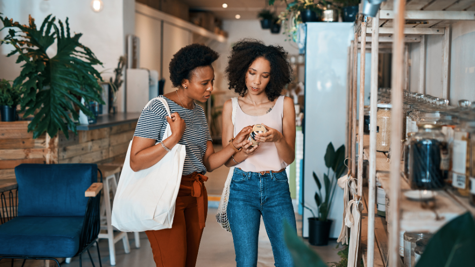 Two shoppers examining the label on a product.